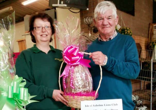 Bev Rockliffe receiving an egg on behalf of the staff at Holmes & Garden's, presented by Isle of Axholme Lion's vice president Graham Guest.