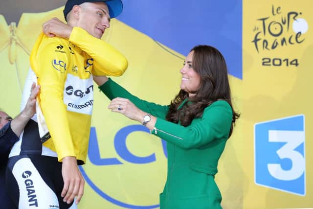 Team Giant Shimano's Marcel Kittel puts on the leaders yellow jersey with help from the Duchess of Cambridge after stage one of the Tour de France in Harrogate, Yorkshire. PRESS ASSOCIATION Photo. See PA story CYCLING Tour. Picture date: Saturday July 5, 2014. Photo credit should read: Martin Rickett/PA Wire