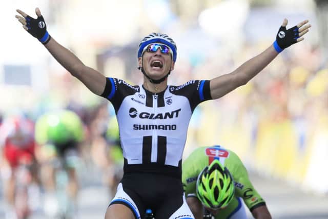 Germany's sprinter Marcel Kittel crosses the finish line ahead of Peter Sagan of Slovakia, right, to win the first stage of the Tour de France cycling race over 190.5 kilometers (118.4 miles) with start in Leeds and finish in Harrogate, England, Saturday, July 5, 2014. (AP Photo/Peter Dejong)