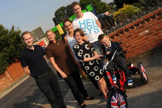 Leo Palmer, three, of Epworth on his new trike with (l-r) his physio Daniel Woods, Leesa Sharpe, Siobhan Edge, Casey Edge, 10, and Rick Palmer. Picture: Andrew Roe