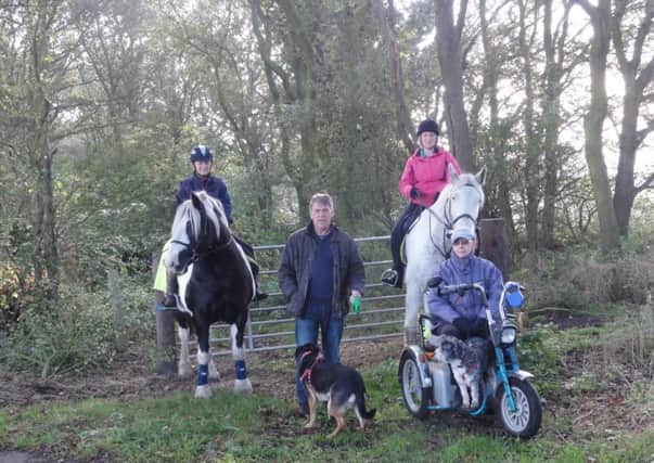 The Friends of Belsahw Wood - (from left) Martin O'Hara, Sheila Saxelby, Eric the gamekeeper, Clive Saxelby and local horse riders.