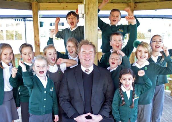 Green Top primary school headteacherNeil Butler, celebrates the schools Ofsted result with school children. Picture: Marie Caley NDFP 12-12-14 Green Top Ofsted MC 2
