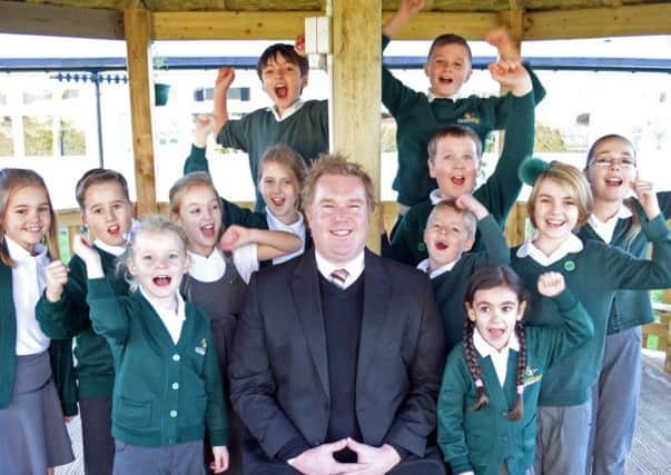Green Top primary school headteacherNeil Butler, celebrates the schools Ofsted result with school children. Picture: Marie Caley NDFP 12-12-14 Green Top Ofsted MC 2