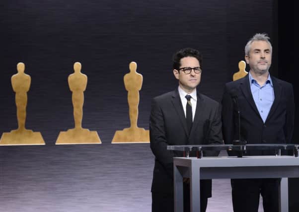 J.J. Abrams, left, and Alfonso Cuaron announce the Academy Awards nominations at the 87th Academy Awards nomination ceremony