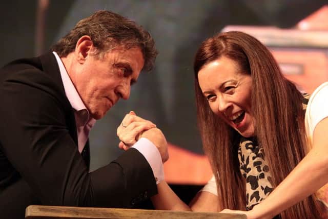 Sly Stallone on stage at Sheffield City Hall arm wrestling