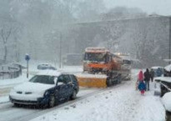 A gritter stuck in traffic during snowfall. Photo by Andy Gregory, Buxton.