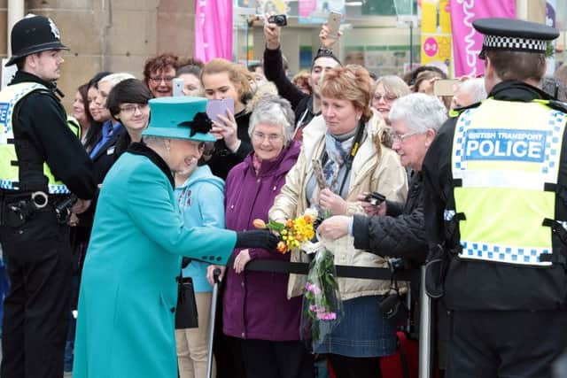 The Queen is greeted by the public at the station