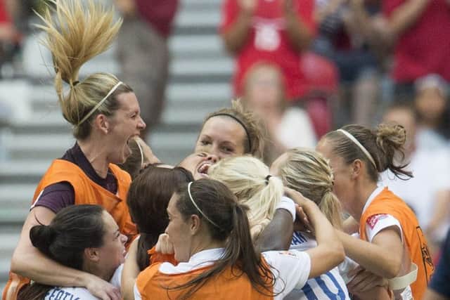 England players celebrate their 2-1 win over Canada following a FIFA Women's World Cup quarterfinal soccer game in Vancouver, British Columbia, Canada, on Saturday, June 27, 2015. (Jonathan Hayward/The Canadian Press via AP)