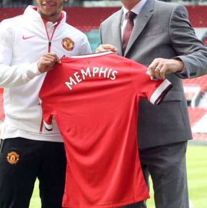 Manchester United's new signing Memphis Depay (left) is unveiled by manager Louis van Gaal during the press conference at Old Trafford, Manchester