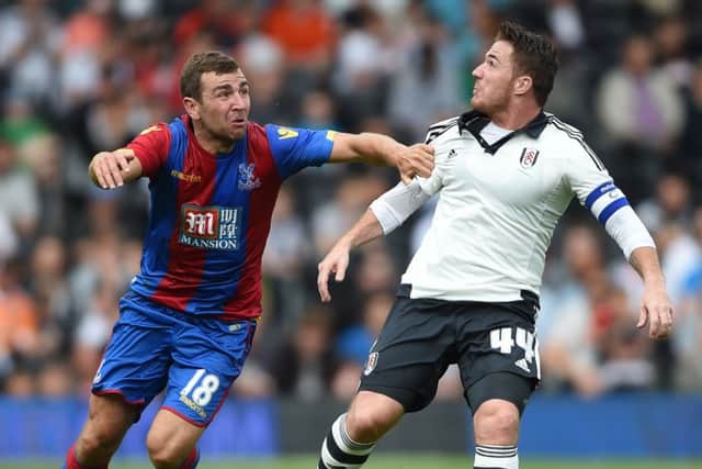 Crystal Palace's James McArther (left) battles with Fulham's Ross McCormack