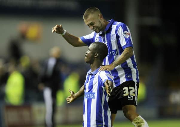 Owls man Modou Sougou scored a late equalising goal against Reading and celebrates with Jack Hunt.