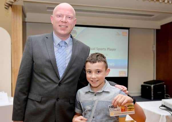 Finlay Matthews receives his award from Chris Bowden, of sponsor McDonald's.