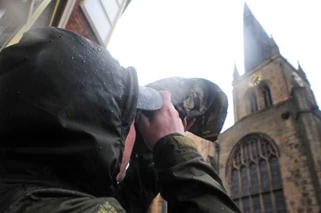 Twitchers gather around the Crooked Spire in Chesterfield for a glimpse of a rare bird.