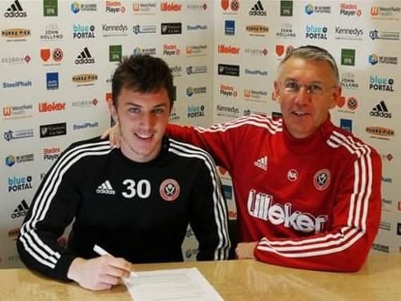 Kieran Wallace signing his new deal at Sheffield United