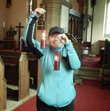 The Reverend Kate Bottley, vicar of Scrooby and star of Gogglebox, with lanterns in her church.
