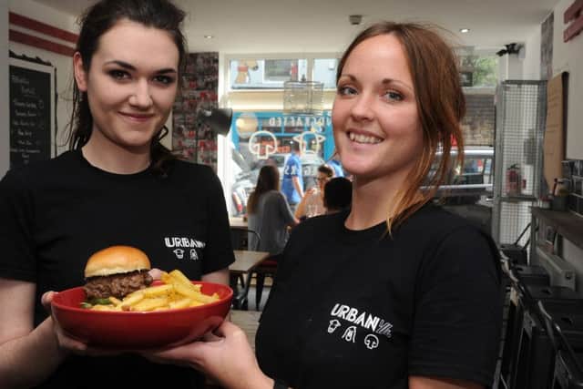 Manager Amy Lonsdale (l) and Front of House Gemma Higginson with a beef burger at Urban Quarter, Sharrow Vale Road. Picture: Andrew Roe