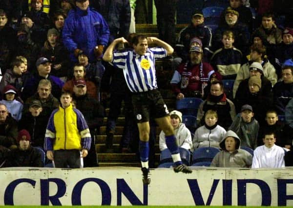 Owls Shefki Kuqi jumps for joy infront of the stunned Burnley fans after his winning goal