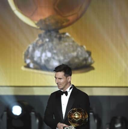 Argentina's Lionel Messi poses with the Ballon d'Or trophy