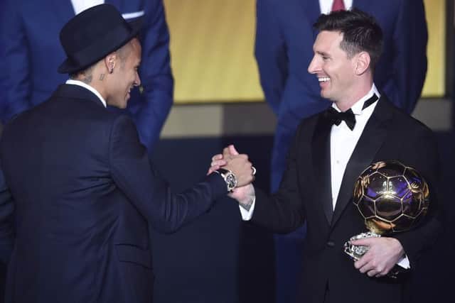 Argentina's Lionel Messi, right, is congratulated by Brazil's Neymar, left, after winning the Ballon d'Or