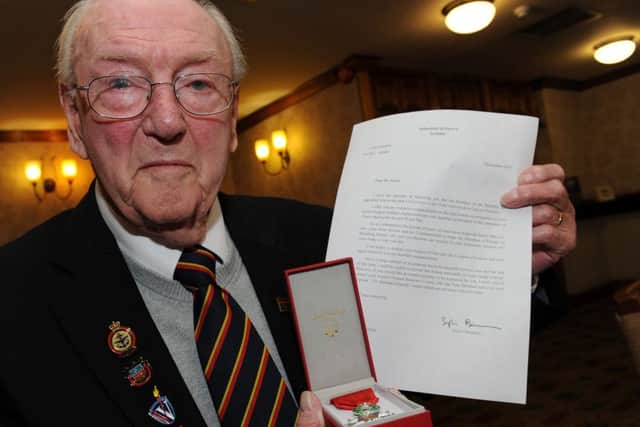 Douglas Austin, with his letter and Legion D'Honneur medal. Picture: Andrew Roe