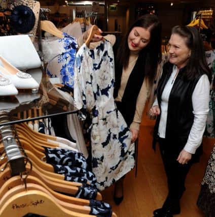Personal shopper Faye Speddings looks through some clothes in Phase Eight at Meadowhall with Jenny Spencer. Picture: Andrew Roe