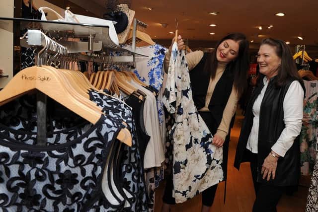 Personal shopper Faye Speddings looks through some clothes in Phase Eight at Meadowhall with Jenny Spencer. Picture: Andrew Roe