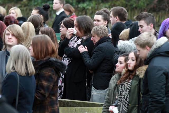 Mourners look on before the service of Sheffield teenager Caroline Everes