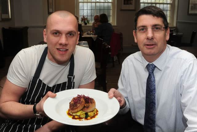 Head chef Simon Ayres (l) and co-owner Stuart Hitchman with the lamb breast dish at the Cross Scythes, Totley. Picture: Andrew Roe