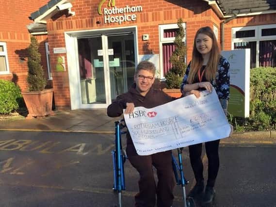 Jacob Hunter hands over his cheque to Rotherham Hospice.