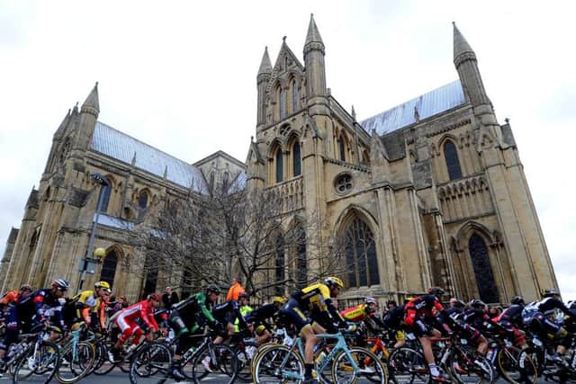 Stage 2 of The Tour De Yorkshire from Selby to York, 174KM, pictured Riders in the main peloton pass Beverley Minster.