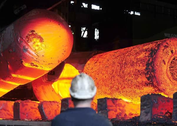 Red hot metal being moved across the heavy forge at the Forgemasters Works in Sheffield. Photo:  John Giles/PA Wire