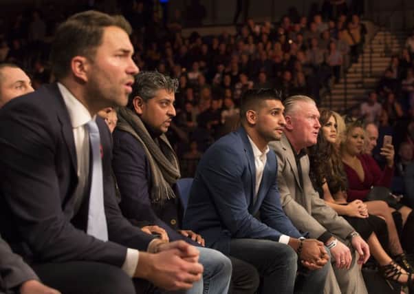 Eddie Hearn, left, with Amir Khan to places to the right