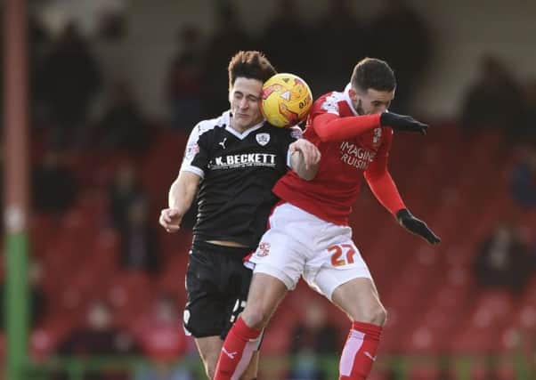 Barnsley's George Williams heads with Bradley Barry. Photo: Dean Atkins