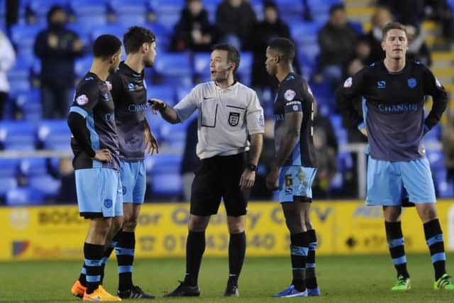 Owls players complain to the referee as no spot-kick is awarded