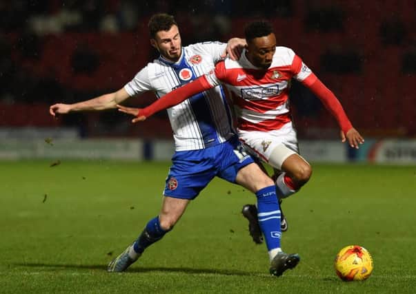 Doncaster 
Rover's Cedric Evina is brought down by Walsall's  Anthony Ford