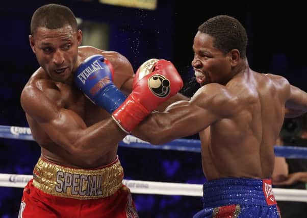 Shawn Porter, right, and Kell Brook trade punches during their IBF welterweight title boxing bout Saturday, Aug. 16, 2014, in Carson, Calif.