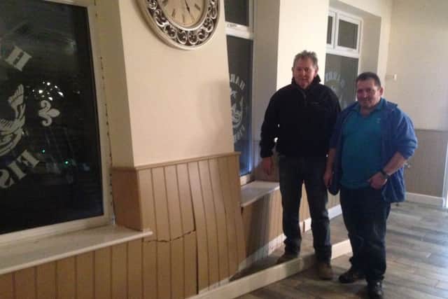 Harry Raouna (r) and builder Trevor Kirsop at Harry's Fish Bar and Restaurant after a car ploughed into the building