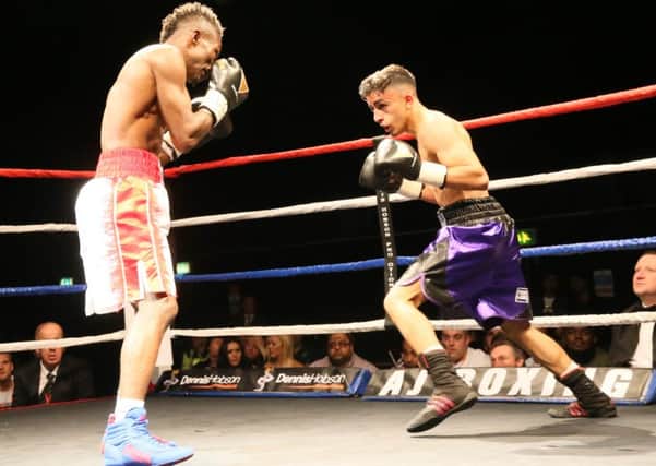 Waleed Din in his last fight against Thomas Essomba (left)
