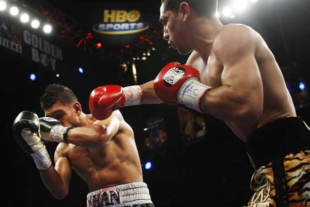 Danny Garcia, right, lands a blow against Amir Khan