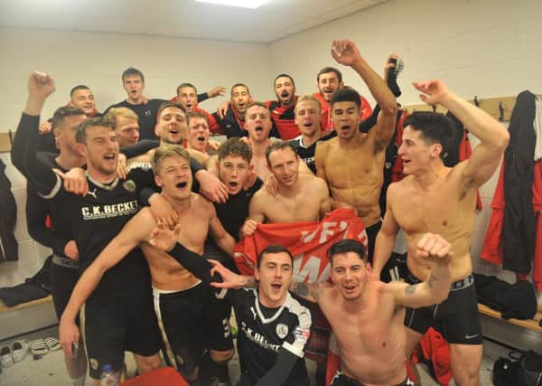 Barnsley players celebrate in the changing room after their penalty shoot-out success.