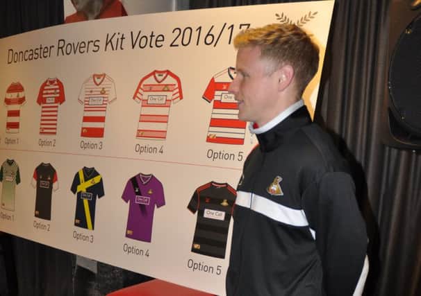 Rovers defender Craig Alcock models some of the new club training wear alongside the shortlisted designs for the new kit.