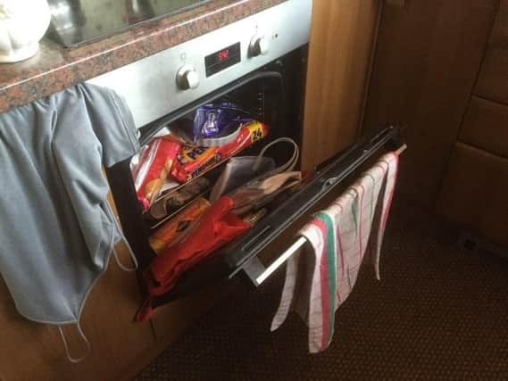 South Yorkshire firefighters discovered an oven stuffed with chocolate, biscuits and bags-for-life during a home-safety check. Picture courtesy of South Yorkshire fire and rescue.