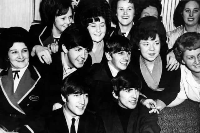 The Beatles with female admirers backstage at the Gaumont.