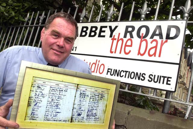 Mick Longworth with the Beatles' signatures.