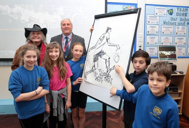 Legendary sports artist Paul Trevillion visits pupils at Dore Primary School in Sheffield to launch a football art competition with the Youdan Trophy. Paul is here with Keith Hackett and some of the pupils, Sheffield, United Kingdom on 4 February 2016. Photo by Glenn Ashley.