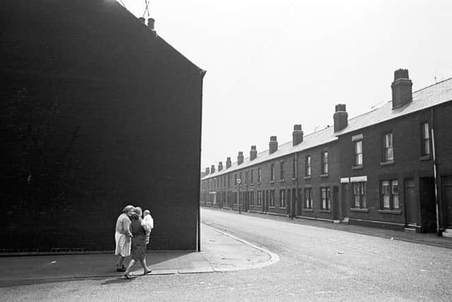 Family walking round the corner, Sheffield 1969, 33-33a. Image taken by Nick Hedges for homeless charity Shelter.