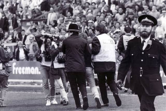 Pictured is what is thought to be  thought to be Inspector Harry White

 on the pitch at the Hillsborough disaster