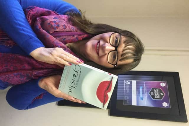 Anne Wilson with book for Womens Day