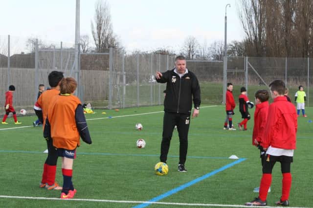 Darren Ferguson gives out instructions to young footballers taking part in Rovers' half term camps