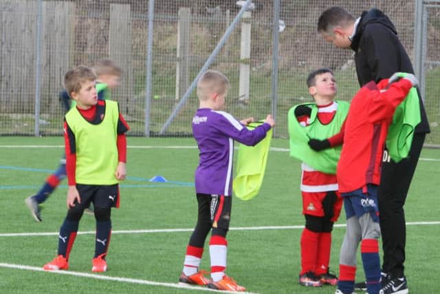 Darren Ferguson chats with young footballers taking part in Rovers' half term training camps